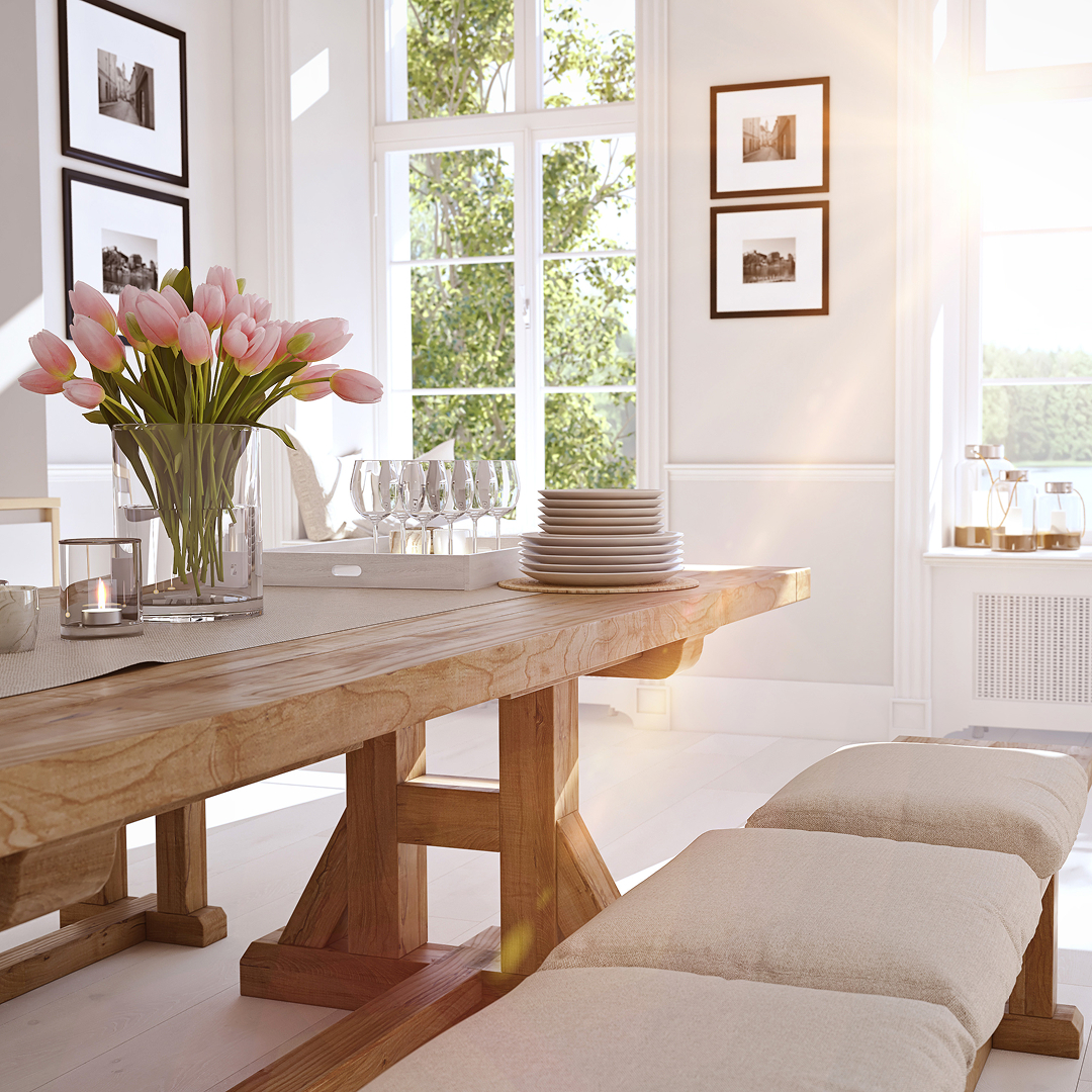 A warm lit dining room with tulips and a fresh table setting.
