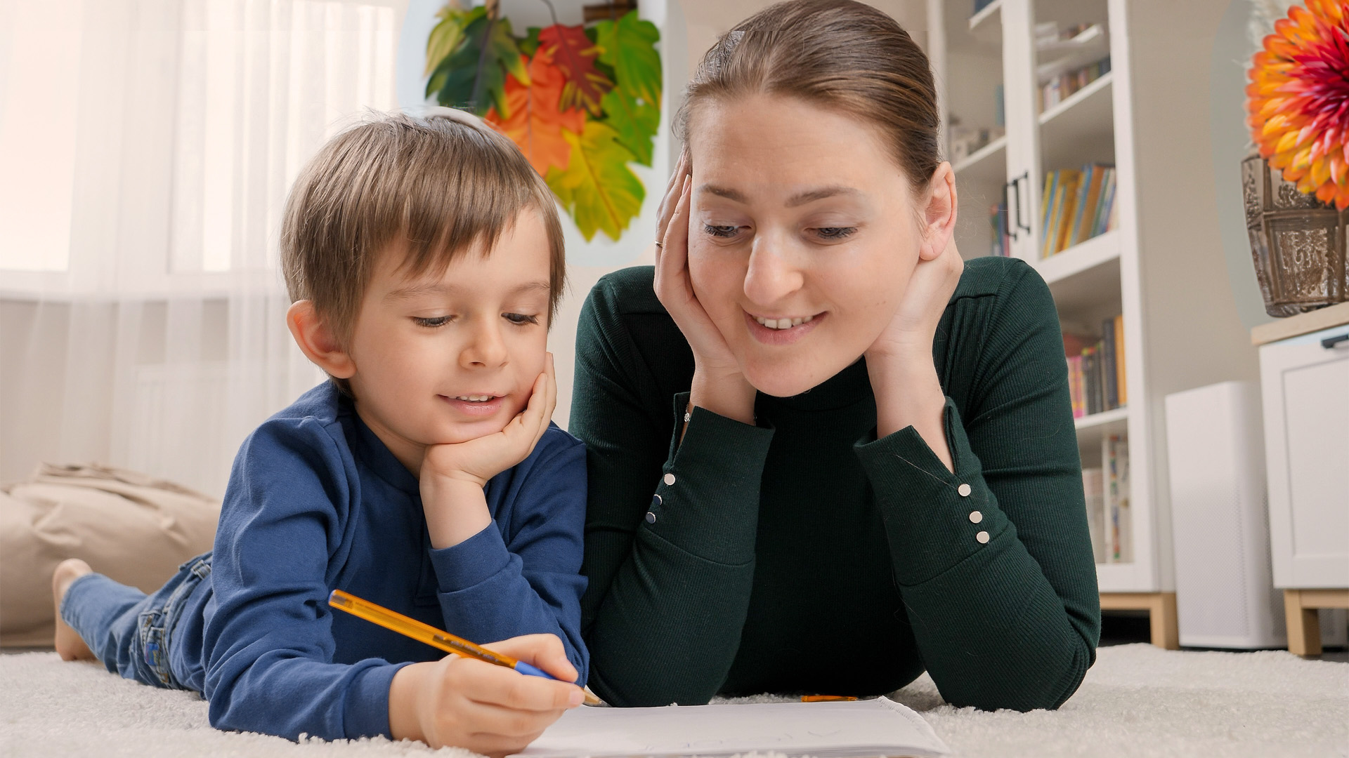 Mother and child enjoying time on a freshly cleaned carpet, illustrating how often carpets should be cleaned to maintain a healthy home.