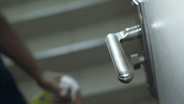 A door handle being cleaned, similar to what might occur prior to a deep cleaning service with Professional Edge Cleaning.